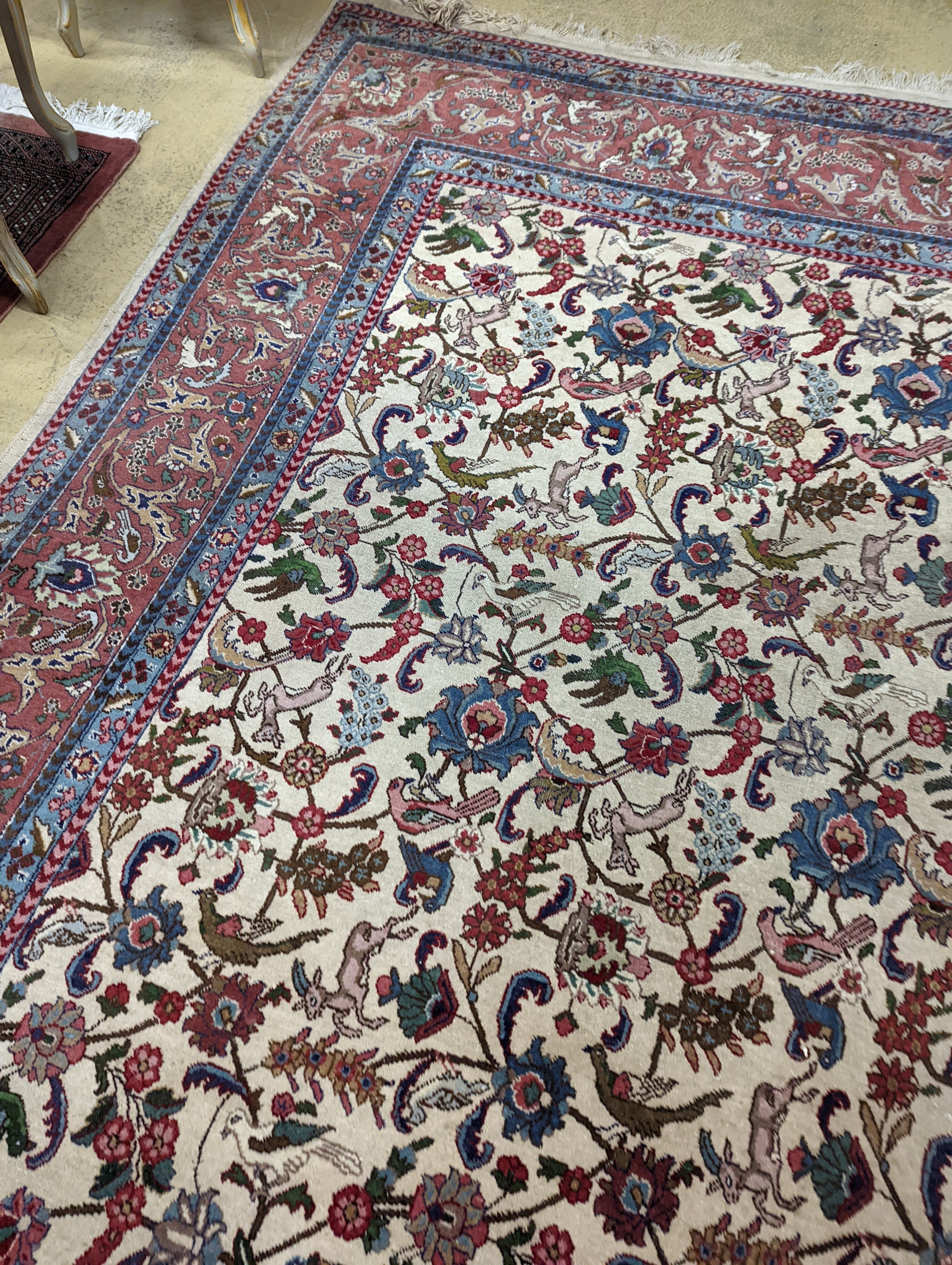 An Ispahan ivory ground carpet woven with flowers and animals, 386 x 276cm